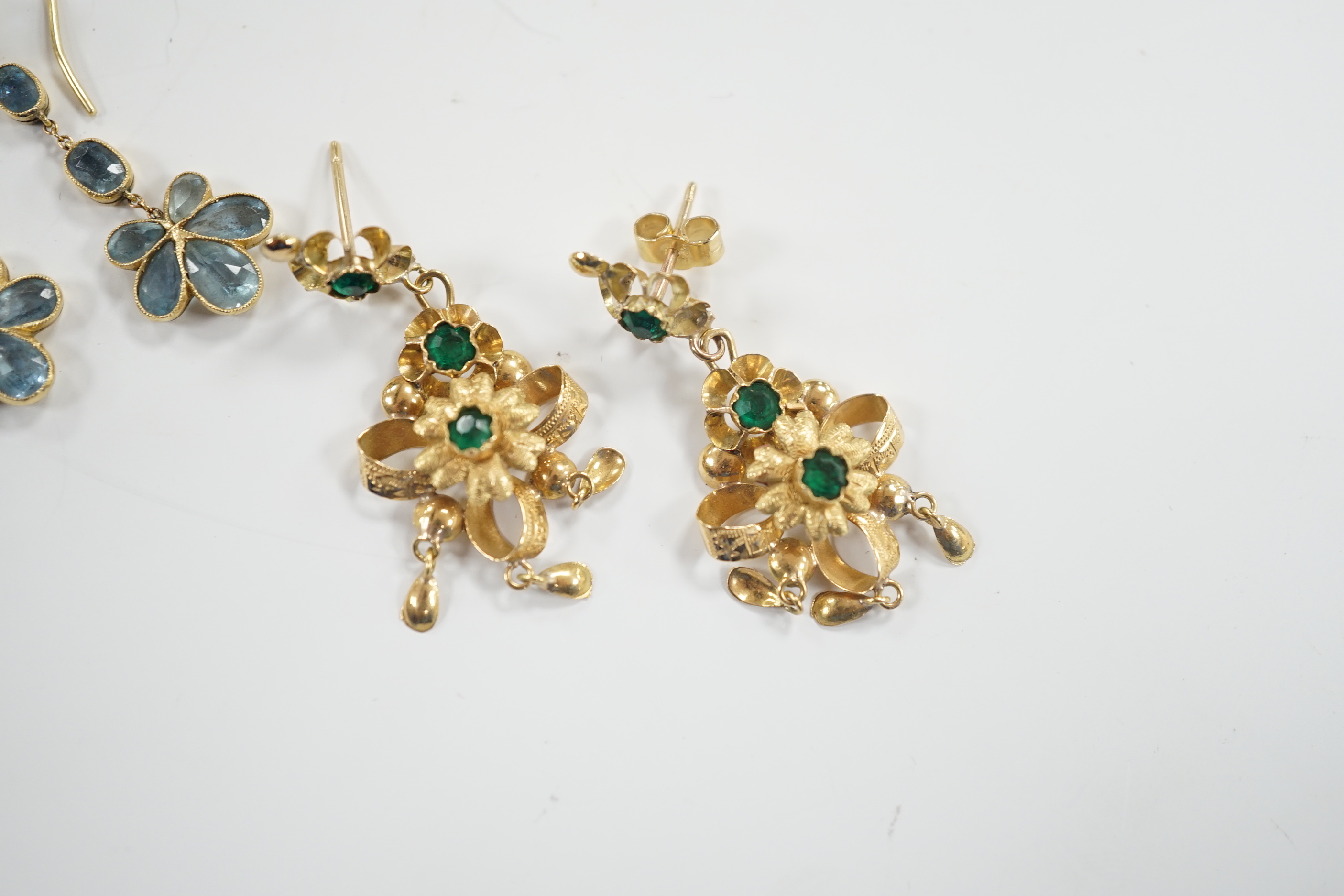 A pair of yellow metal and green paste set drop earrings, 41mm and a pair of yellow metal and aquamarine set cluster drop earrings, gross weight 7.3 grams.